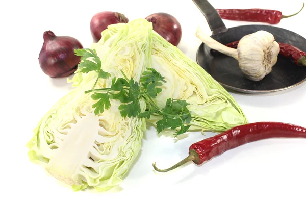 Sweetheart cabbage with onions in a pan — Stock Photo, Image