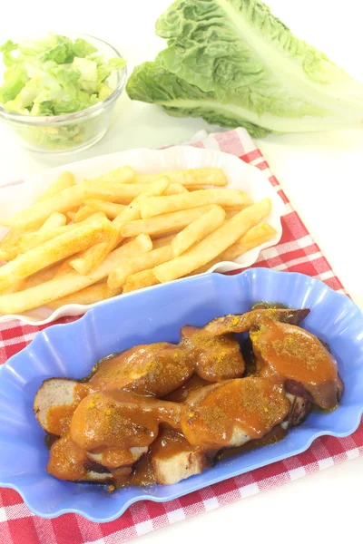 Currywurst with french fries with salad — Stock Photo, Image