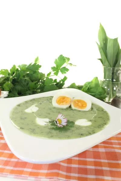 Herbs soup with eggs and a dollop of cream — Stock Photo, Image