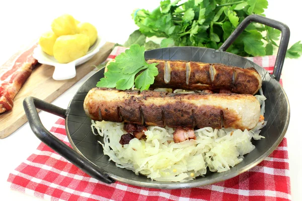 Fried sausage with sourcrout — Stock Photo, Image