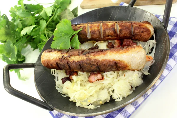Fried sausage with sourcrout — Stock Photo, Image