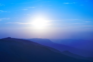 Beautiful sunset at the mountains clipart