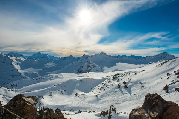 Snowy blue mountains in clouds — Stock Photo, Image