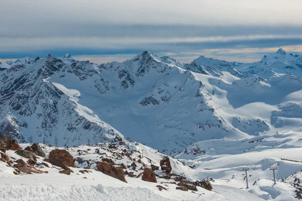 Snowy blue mountains in clouds — Stock Photo, Image