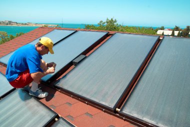 Worker installs solar panels  clipart