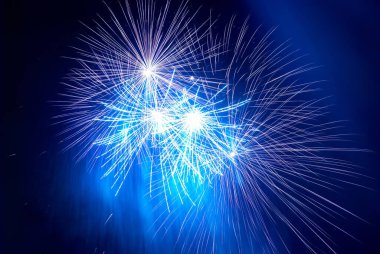 Blue holiday fireworks on black night sky