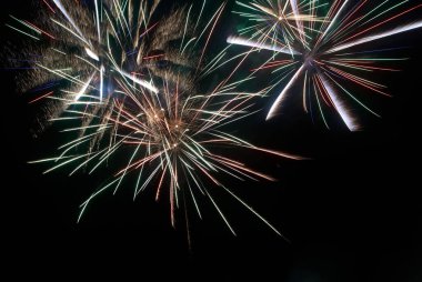Kara gökyüzü arka planında renkli havai fişekler