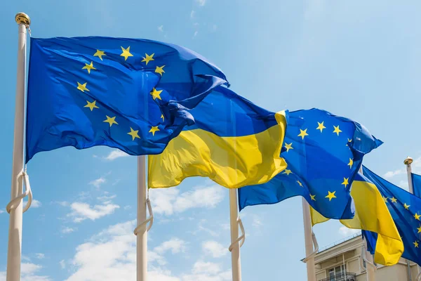 Ukraine European Union Flags Poles Fluttering Wind Blue Sky Ukrainian — Stock Photo, Image