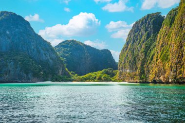Panorama of Phi Phi famous island in Thailand with sea, boats and mountains in beautiful lagoon where the Beach movie was filmed