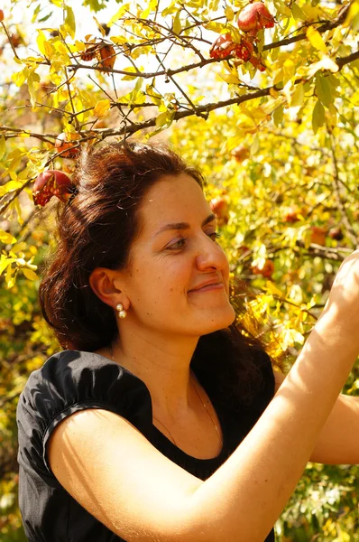 Woman in an autumn garden — Stock Photo, Image