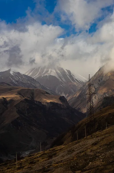Highest Mount Georgia Kazbegi Covered Clouds First Snow Slopes Late — стоковое фото