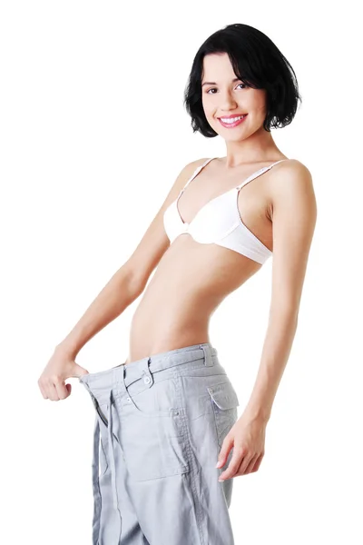 Young fit woman with big pants — Stock Photo, Image