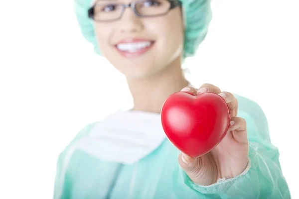 Female doctor or nurse holding heart — Stock Photo, Image