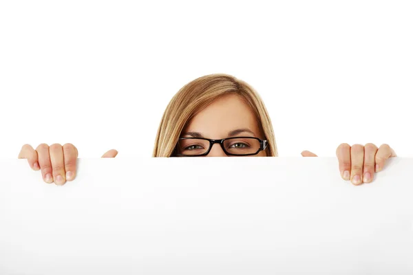 Happy smiling young woman showing blank signboard Stock Picture