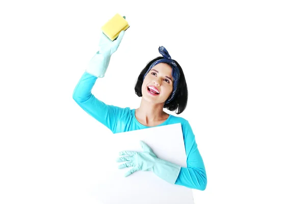 Cleaning woman showing blank sign board. — Stock Photo, Image