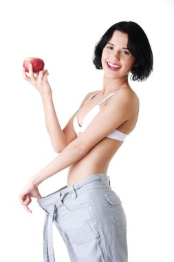 Young woman showing how much weight did she lost. clipart