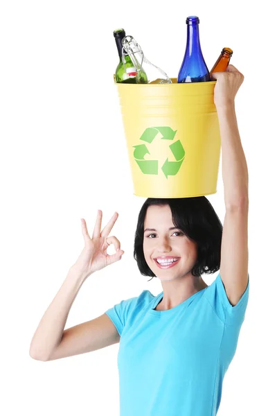 Beautiful young woman holding recycling basket — Stock Photo, Image