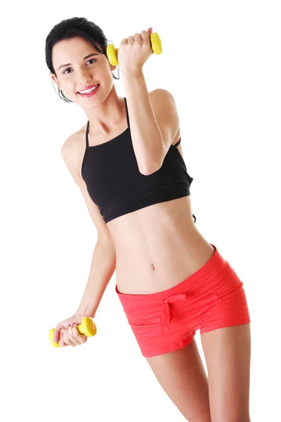 Fitness girl is working out with dumbbells — Stock Photo, Image