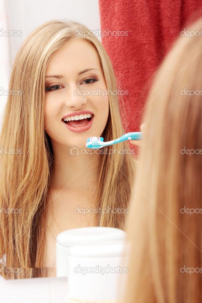 Pretty female brushing her teeth