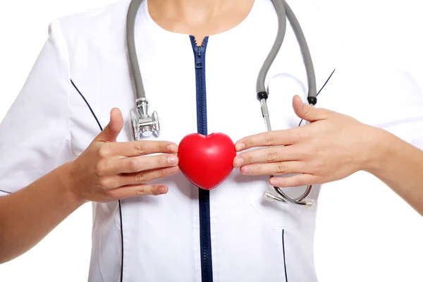 Female doctor holding red heart in hand — Stock Photo, Image