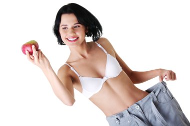 Young woman showing how much weight did she lost.