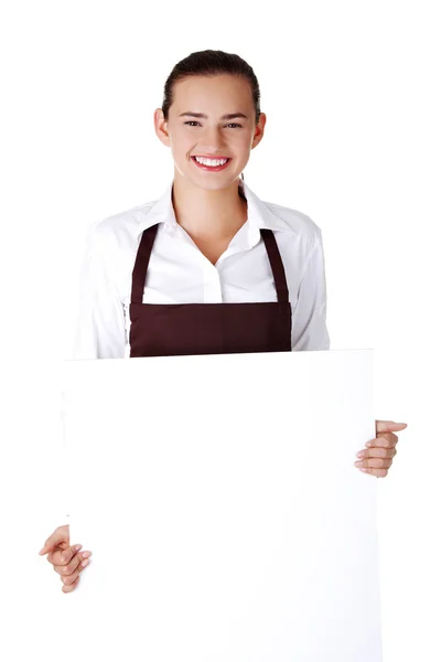 Elegant woman in apron holding blank board — Stock Photo, Image