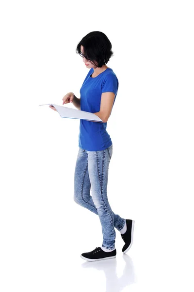 Молодая женщина читает тетрадь для школы . — стоковое фото