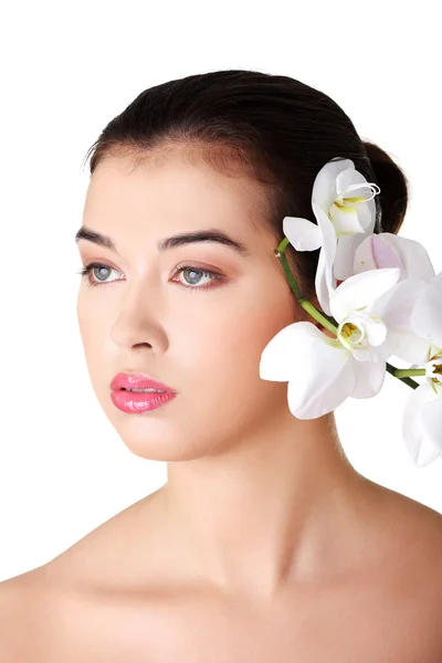 Portrait of beautiful young woman with orchid flower — Stock Photo, Image