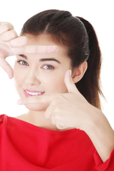 Happy girl with face in frame of palms. — Stock Photo, Image