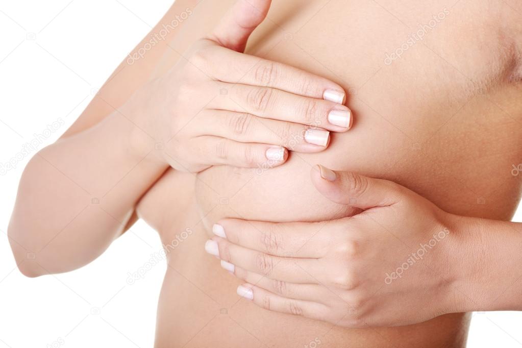 Woman examining breast mastopathy or cancer