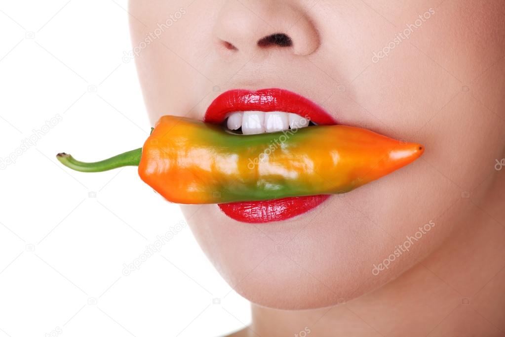 Beautiful woman lips with hot paprika
