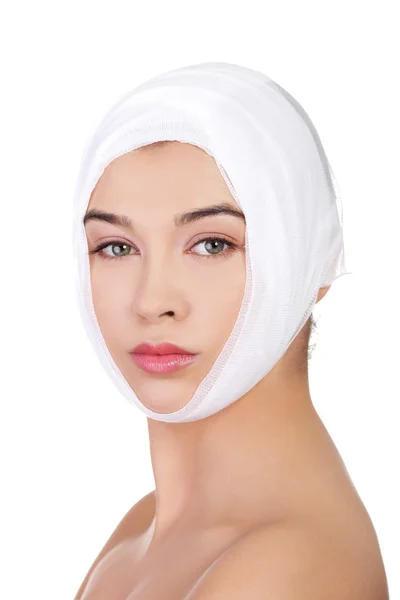 Beautiful young female face with bandage — Stock Photo, Image