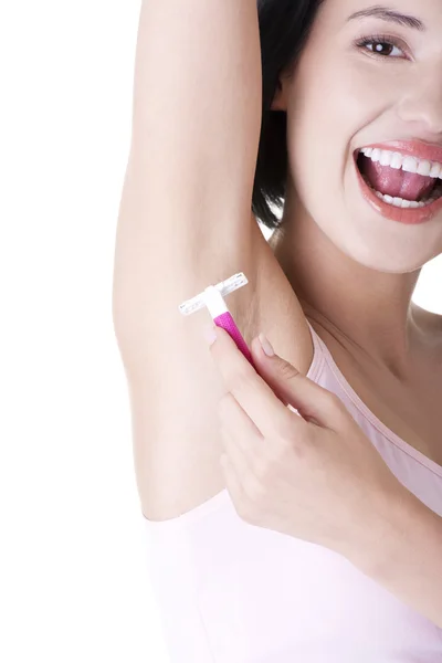 Smiling young woman shaving her armpit — Stock Photo, Image