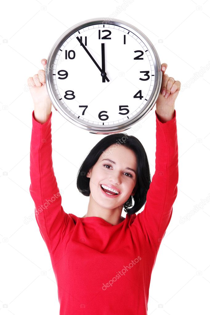 Happy young woman holding office clock