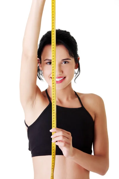 Pretty smiling woman holding measurement type — Stock Photo, Image