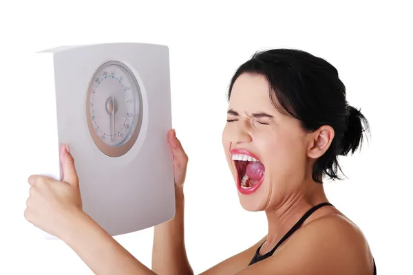 Frustrated woman with scale — Stock Photo, Image