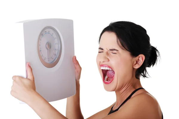 Frustrated woman with scale — Stock Photo, Image