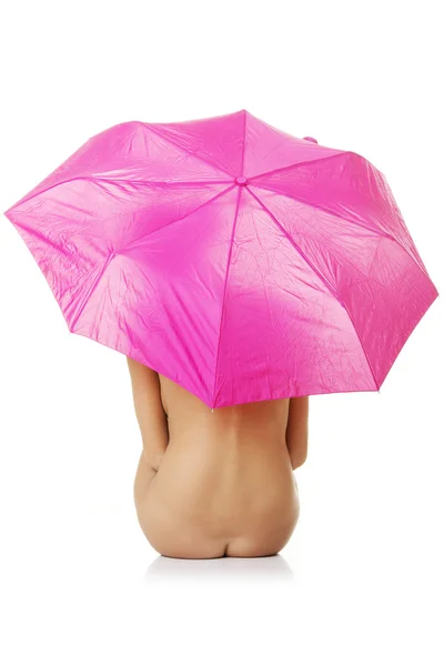 Beautiful nude woman under pink umbrella — Stock Photo, Image