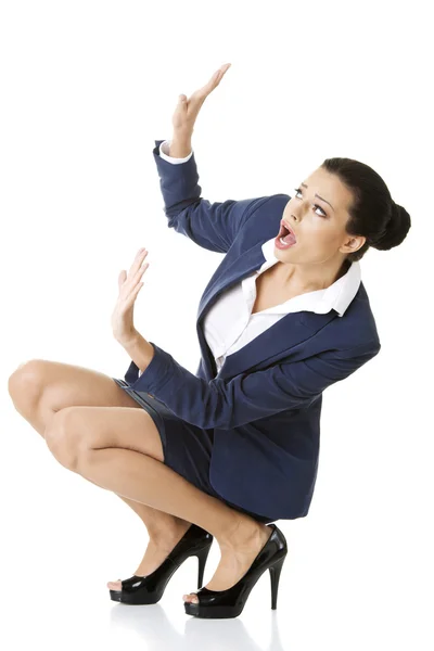 Scared businesswoman defending herself Royalty Free Stock Images