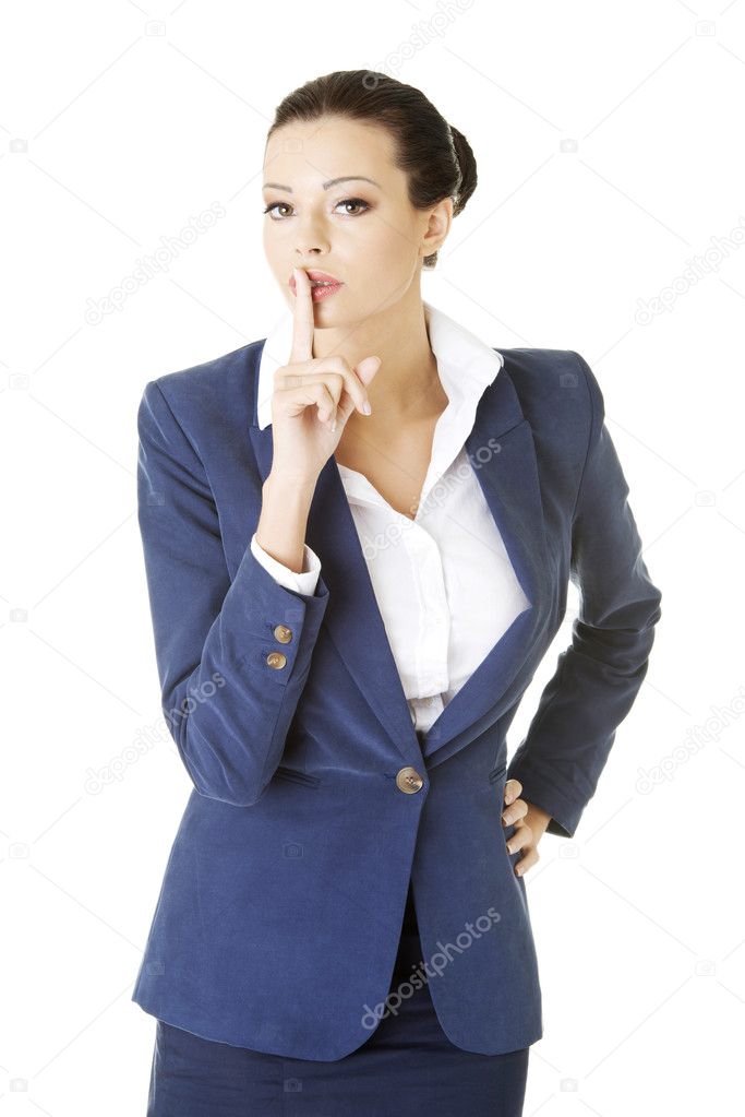 Attractive business woman with finger on lips
