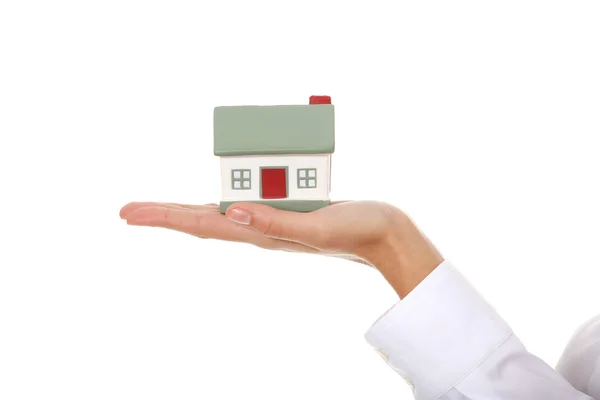 Young businesswoman with house model on hand — Stock Photo, Image