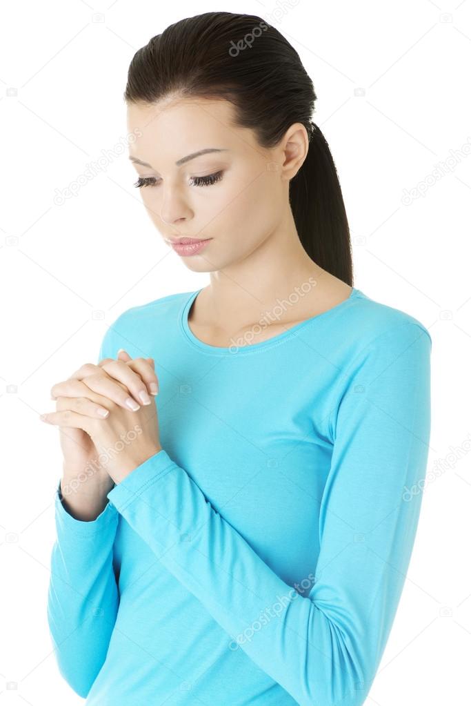 Portrait of a young caucasian woman praying