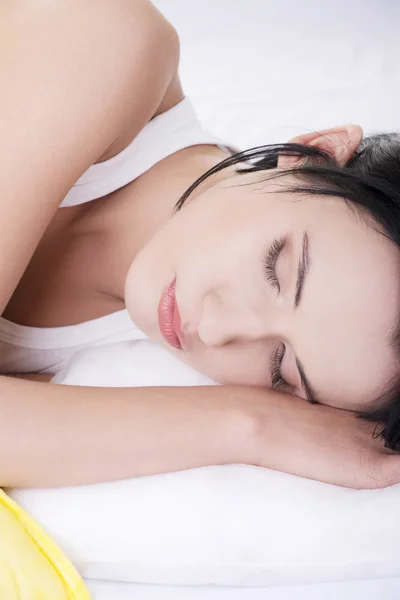 Beautiful young woman resting in bed — Stock Photo, Image