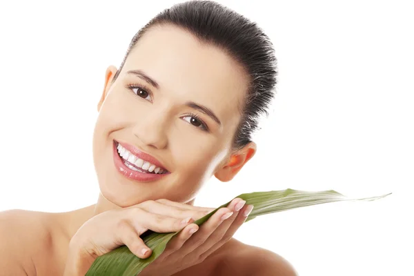 Young beautiful smiling woman with green leaf — Stock Photo, Image