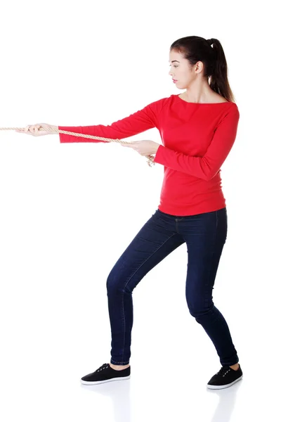 Casual woman pulling a rope — Stock Photo, Image