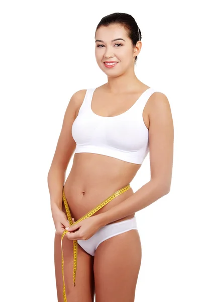 Pretty smiling woman with measurement type — Stock Photo, Image