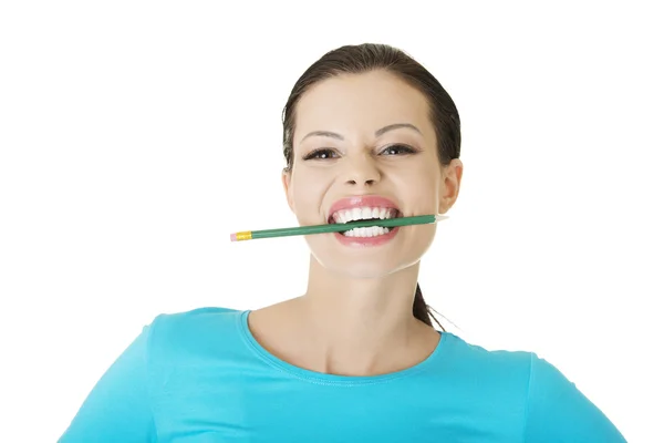 Thoughtful woman biting pencil — Stock Photo, Image