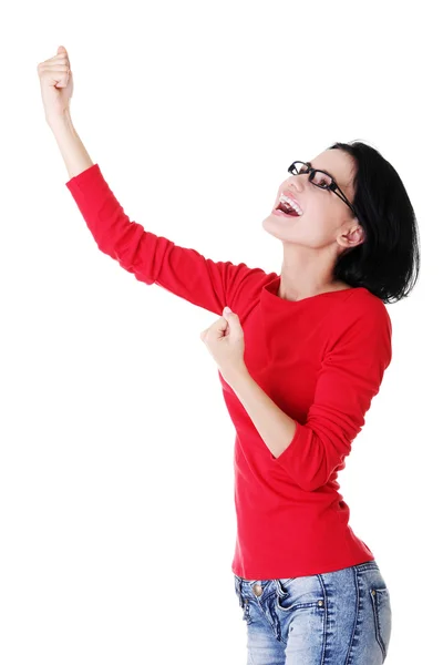 Excited young woman with fists up Stock Photo