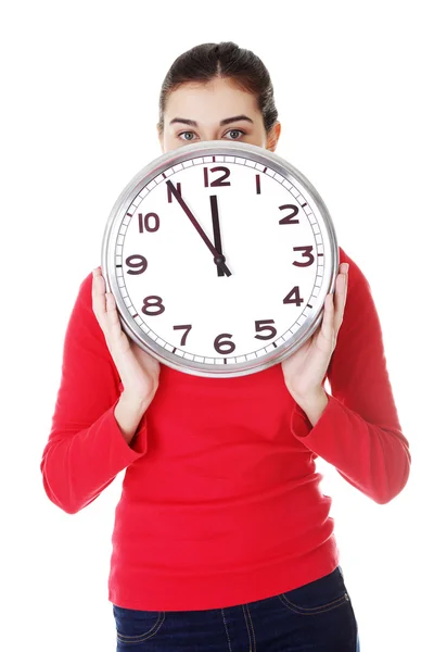 Shocked woman holding office clock Stock Image