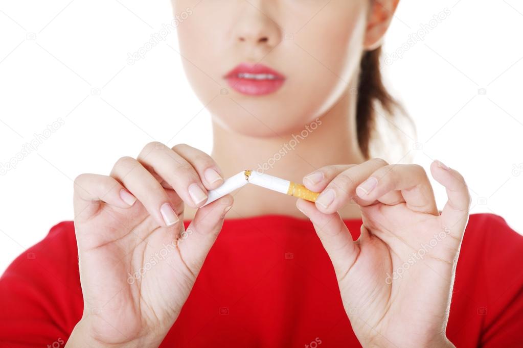 Young woman with broken cigarette.